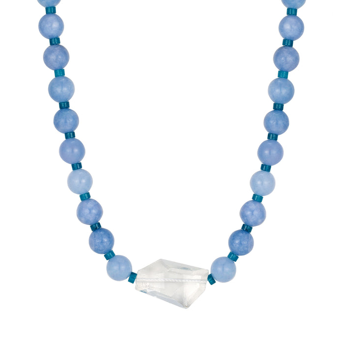 Necklace with blue beads and a clear crystal pendant on a white background