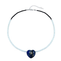 Necklace with a blue heart-shaped pendant on a white background