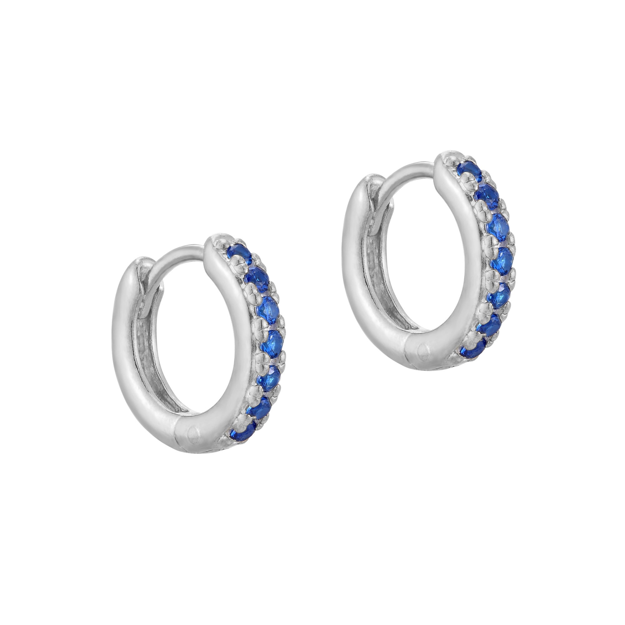 A pair of sterling silver huggie hoop earrings with blue cubic zirconia stones, displayed against a white background - seolgold