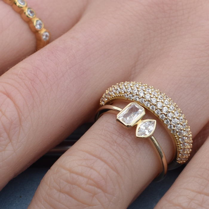 Gold ring with diamond accents on a finger - seolgold