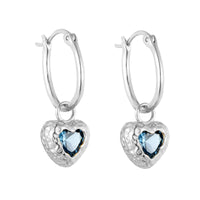 Silver heart-shaped earrings with blue gemstones on a white background - seolgold