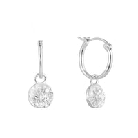 Silver hoop earrings with round textured charms on a white background - seolgold