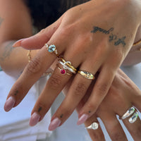 Close-up of a hand with multiple rings on fingers - seolgold