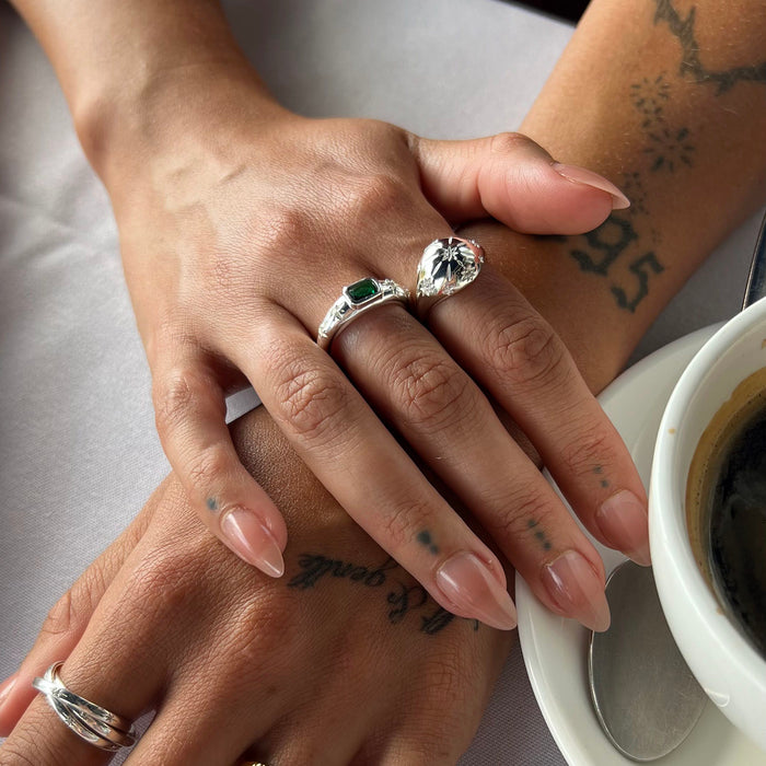 Close-up of two hands with rings on a table with a coffee cup - seolgold