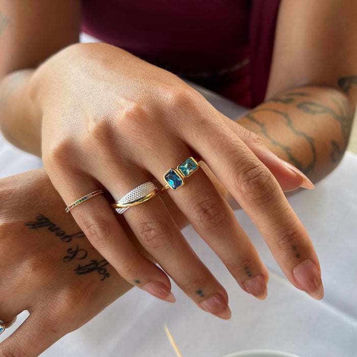 Close-up of a hand wearing multiple rings with a white background - seolgold