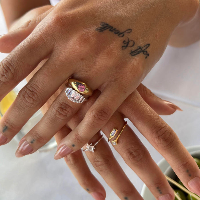 Close-up of hands with gold and silver rings on a blurred background - seolgold