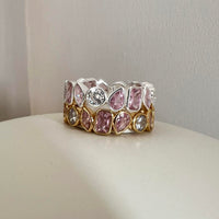 Ring with pink gemstones and clear crystals on a neutral background - seolgold