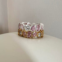 Ring with pink gemstones and clear crystals on a neutral background - seolgold