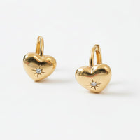 Gold heart-shaped earrings with small diamonds on a white background - seolgold