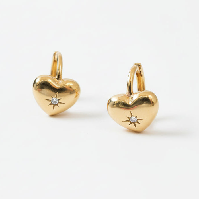 Gold heart-shaped earrings with small diamonds on a white background - seolgold