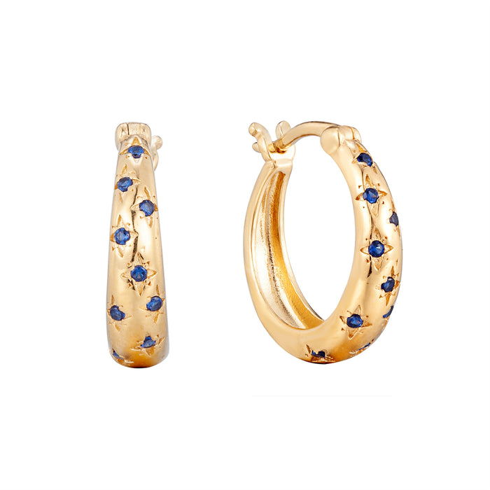 Gold hoop earrings with blue gemstones on a white background - seolgold