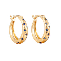 Gold hoop earrings with blue gemstones on a white background - seolgold
