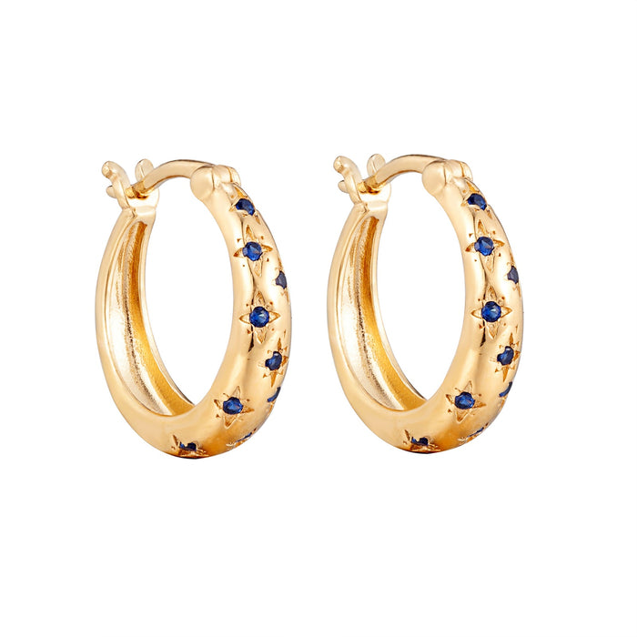 Gold hoop earrings with blue gemstones on a white background - seolgold