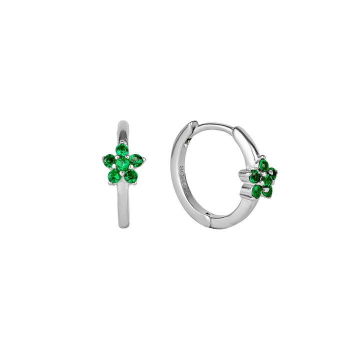 Silver hoop flower earrings with green gemstones on a white background