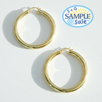 Gold hoop earrings on a white background with S+G Sample Sale logo - seolgold