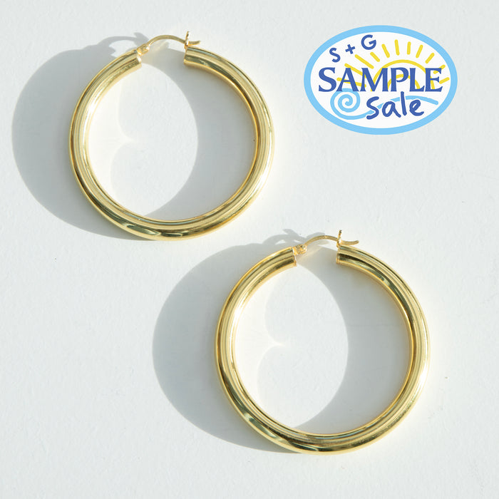 Gold hoop earrings on a white background with S+G Sample Sale logo - seolgold