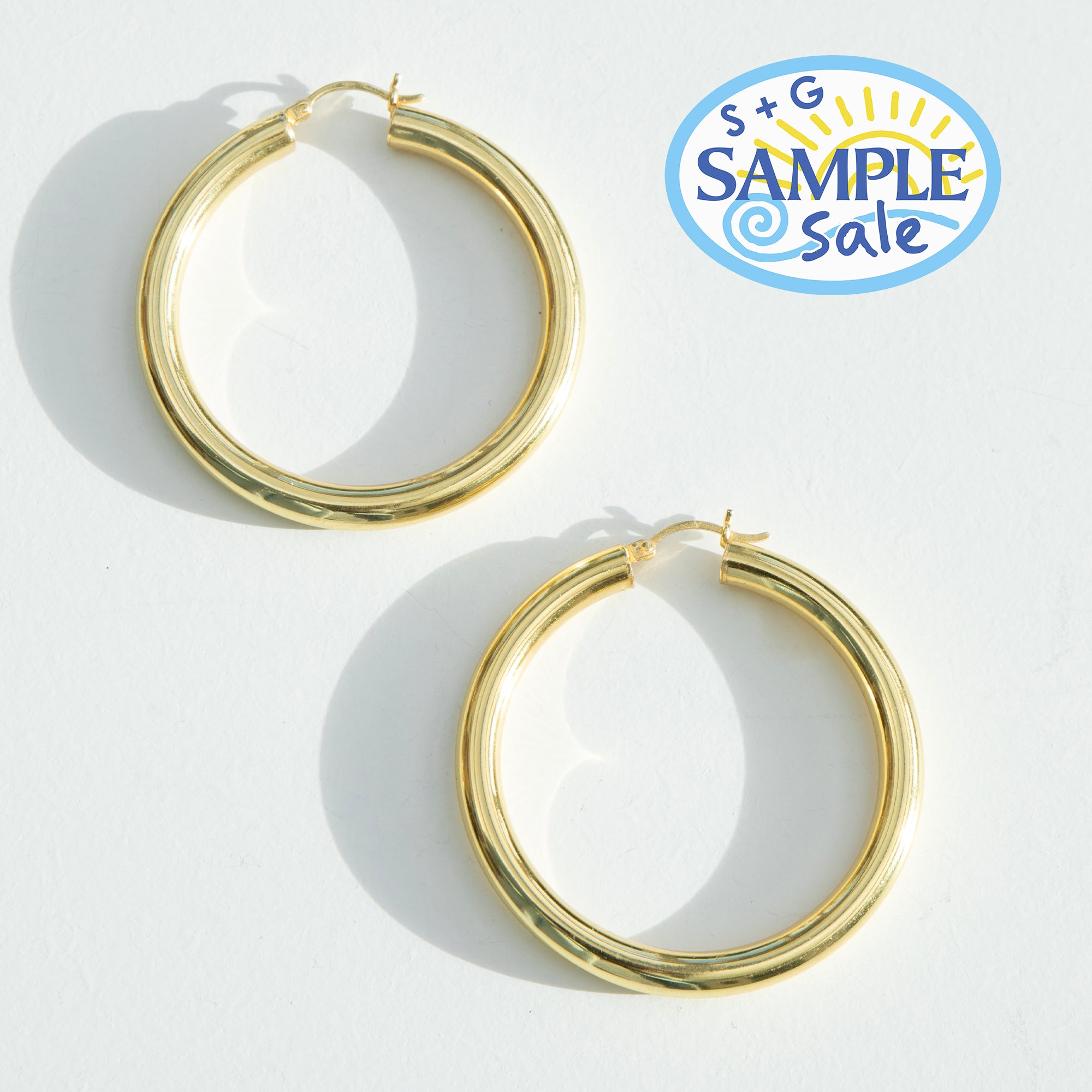 Gold hoop earrings on a white background with 'S+G Sample Sale' logo - seolgold