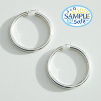 Silver hoop earrings on a light gray background with 'S+G Sample Sale' logo - seolgold
