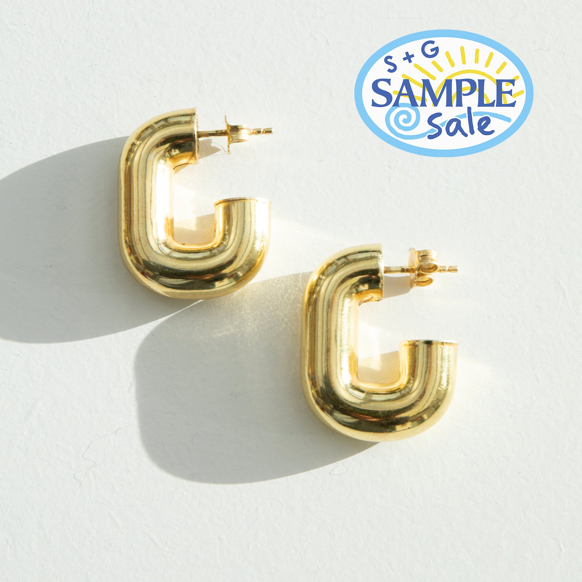 Gold hoop earrings on a white background with a 'S+G Sample Sale' logo - seolgold
