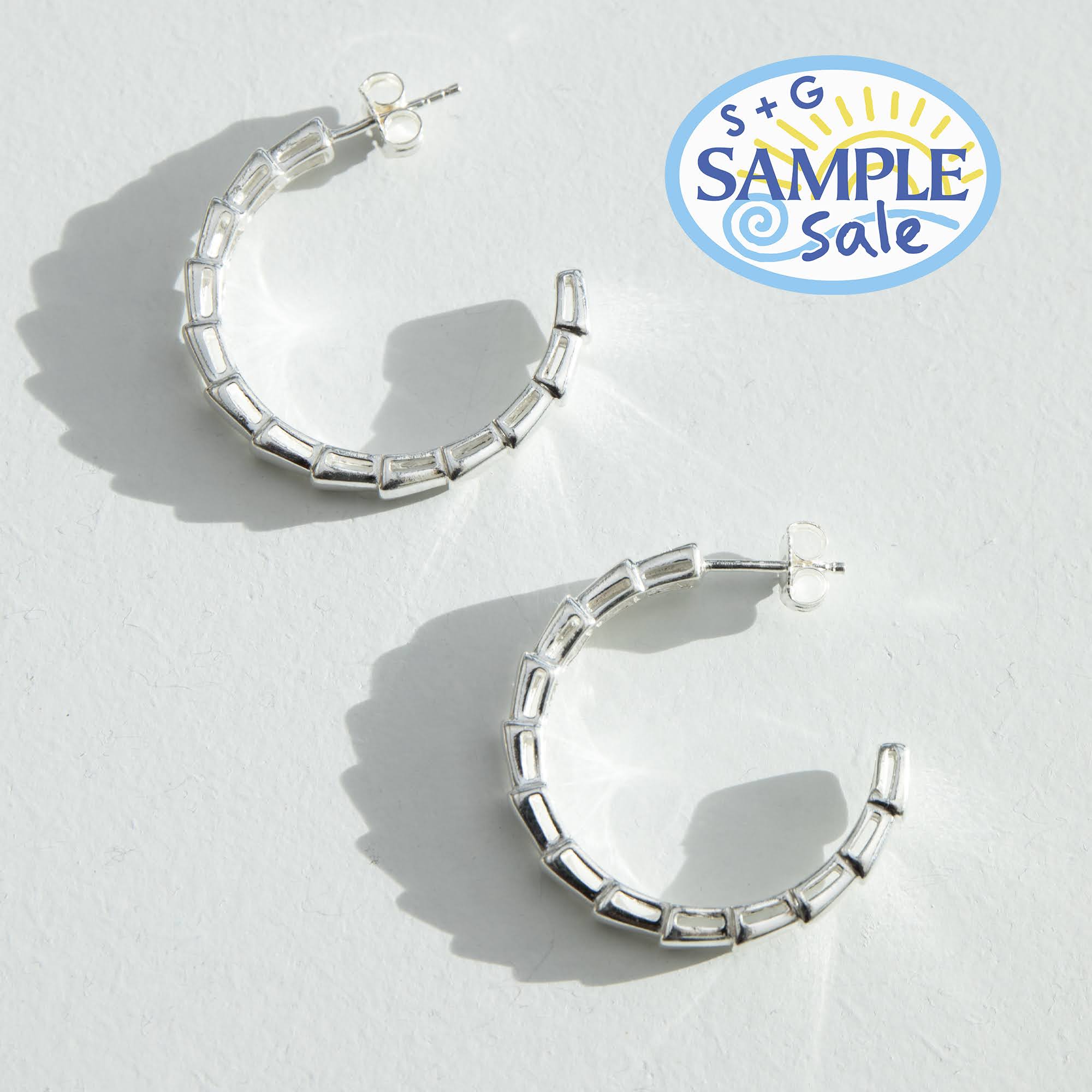 Silver hoop earrings on a light gray background with 'S+G Sample Sale' logo - seolgold