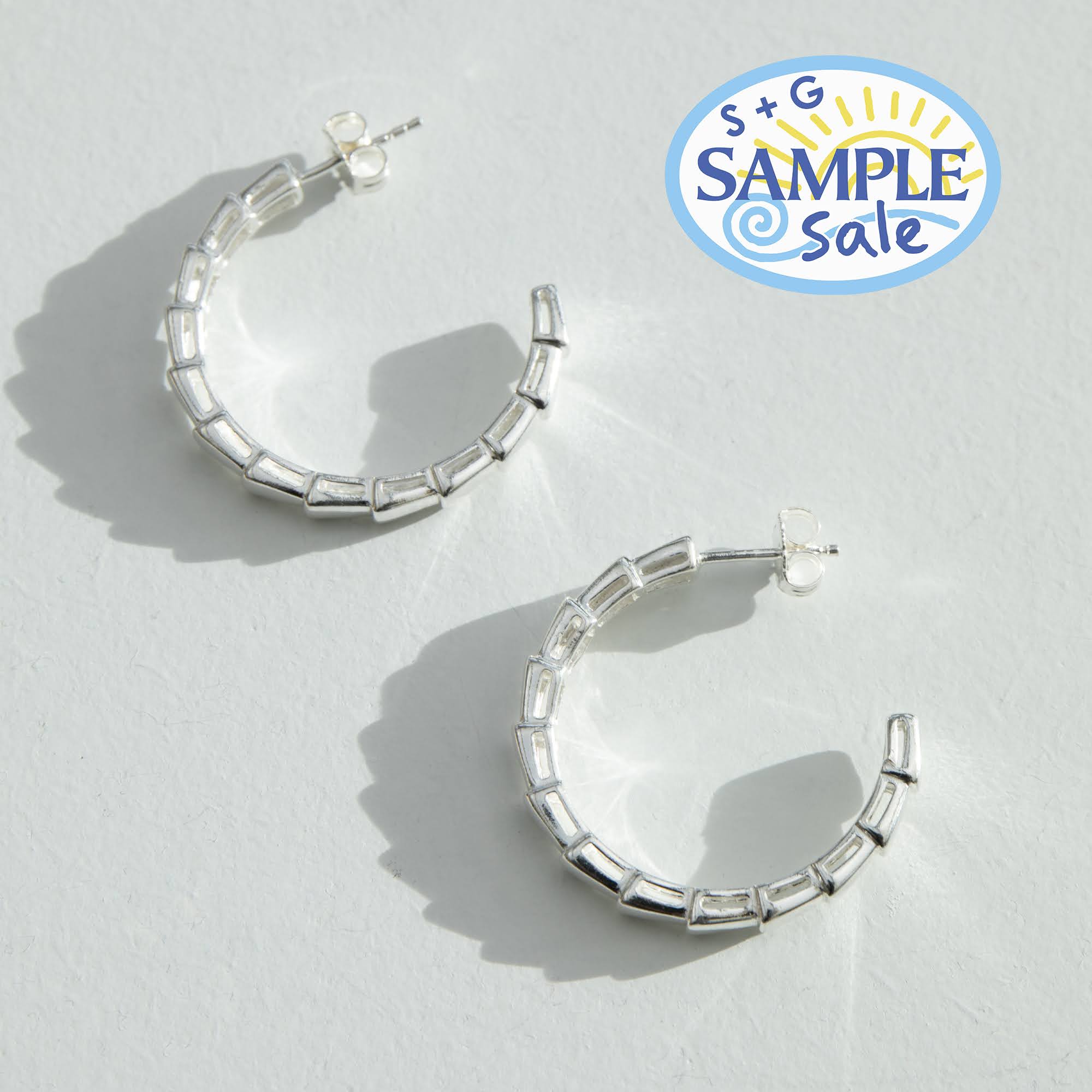 Silver hoop earrings on a light gray background with 'S+G Sample Sale' logo - seolgold