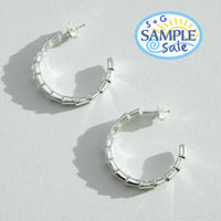 Silver hoop earrings on a light gray background with 'S+G Sample Sale' logo - seolgold