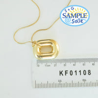 Gold necklace with a pendant on a white background with a ruler for scale - seolgold