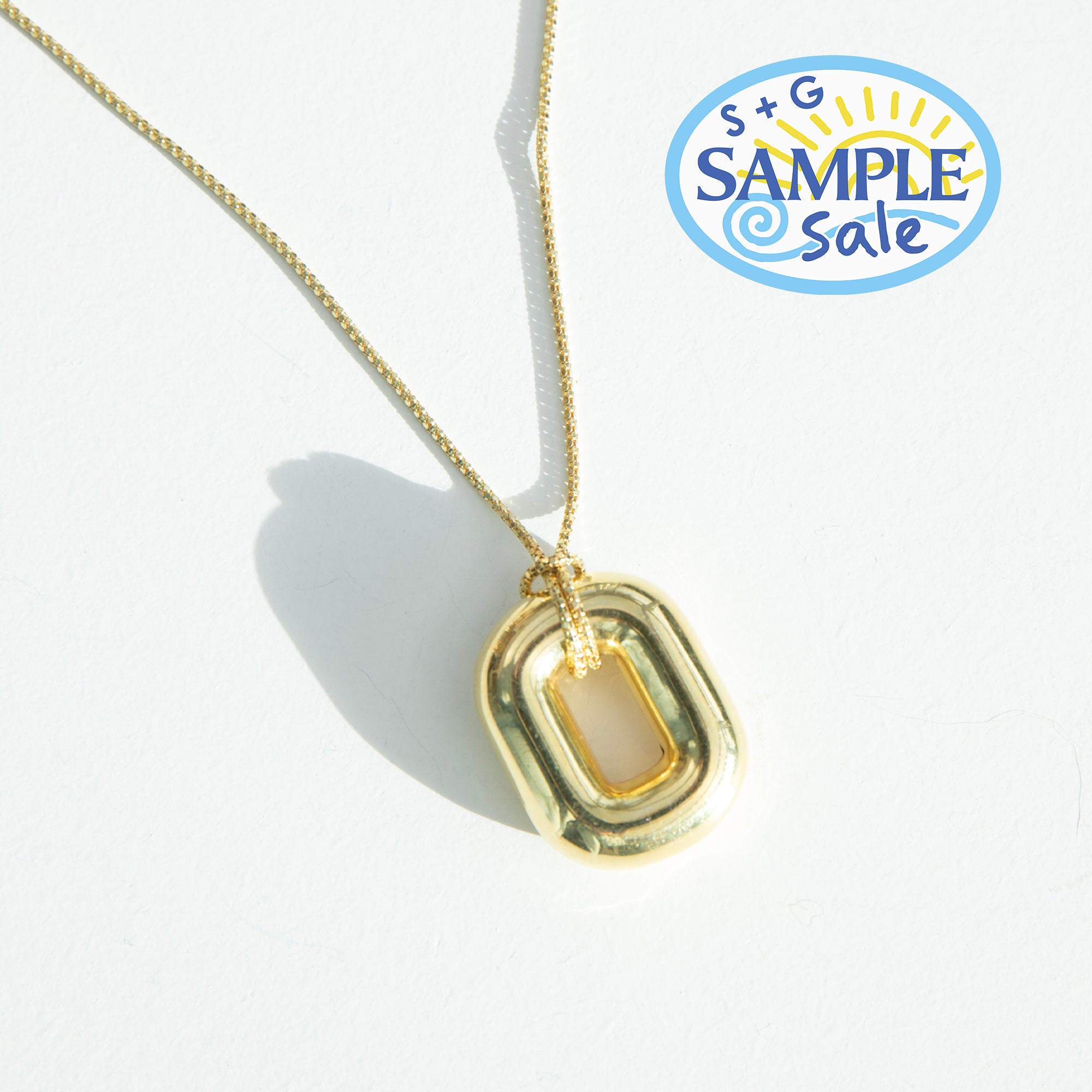 Gold necklace with a pendant on a white background, featuring 'S+G Sample Sale' logo - seolgold