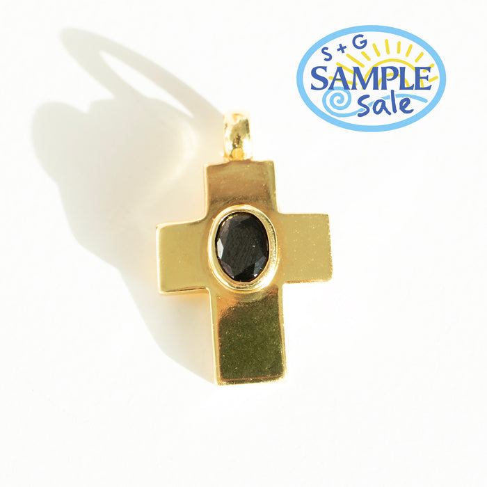 Gold cross pendant with black stone on a white background, featuring S+G Sample Sale logo.
