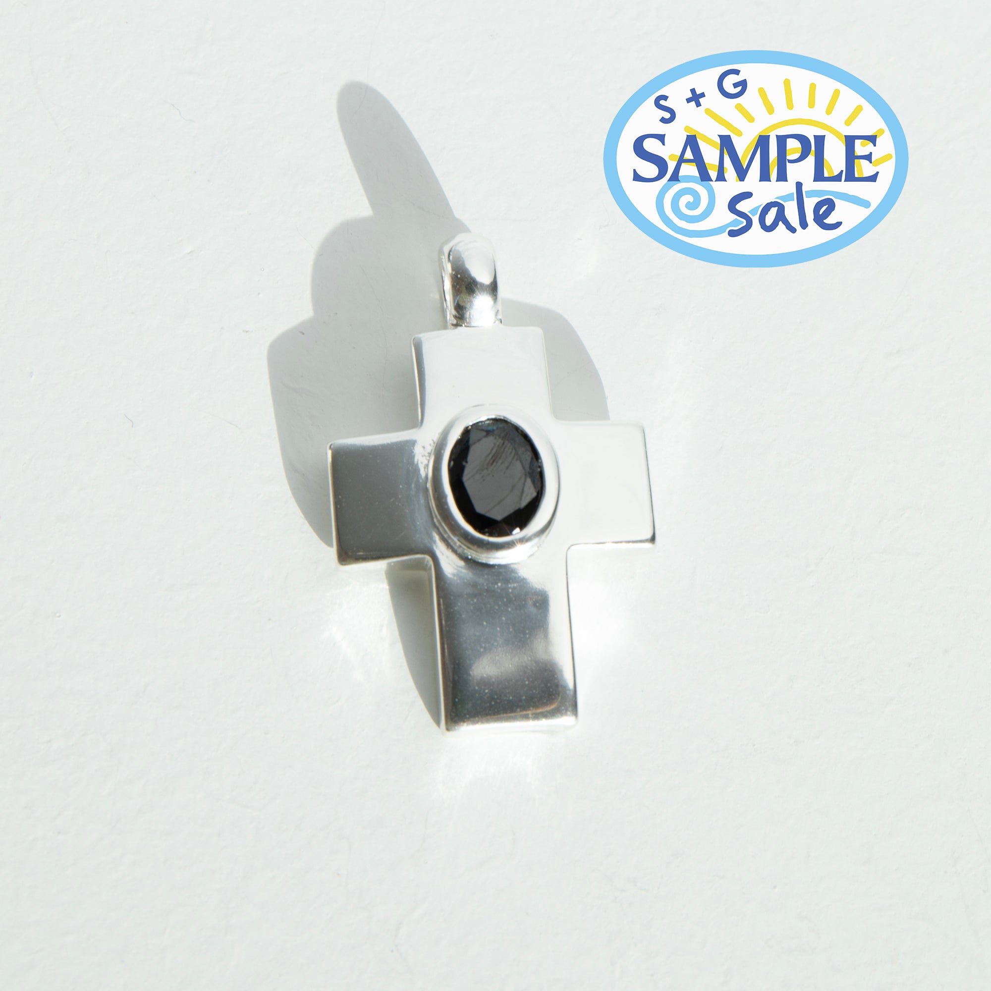 Silver pendant with a black gemstone on a white background, featuring 'S+G Sample Sale' logo.