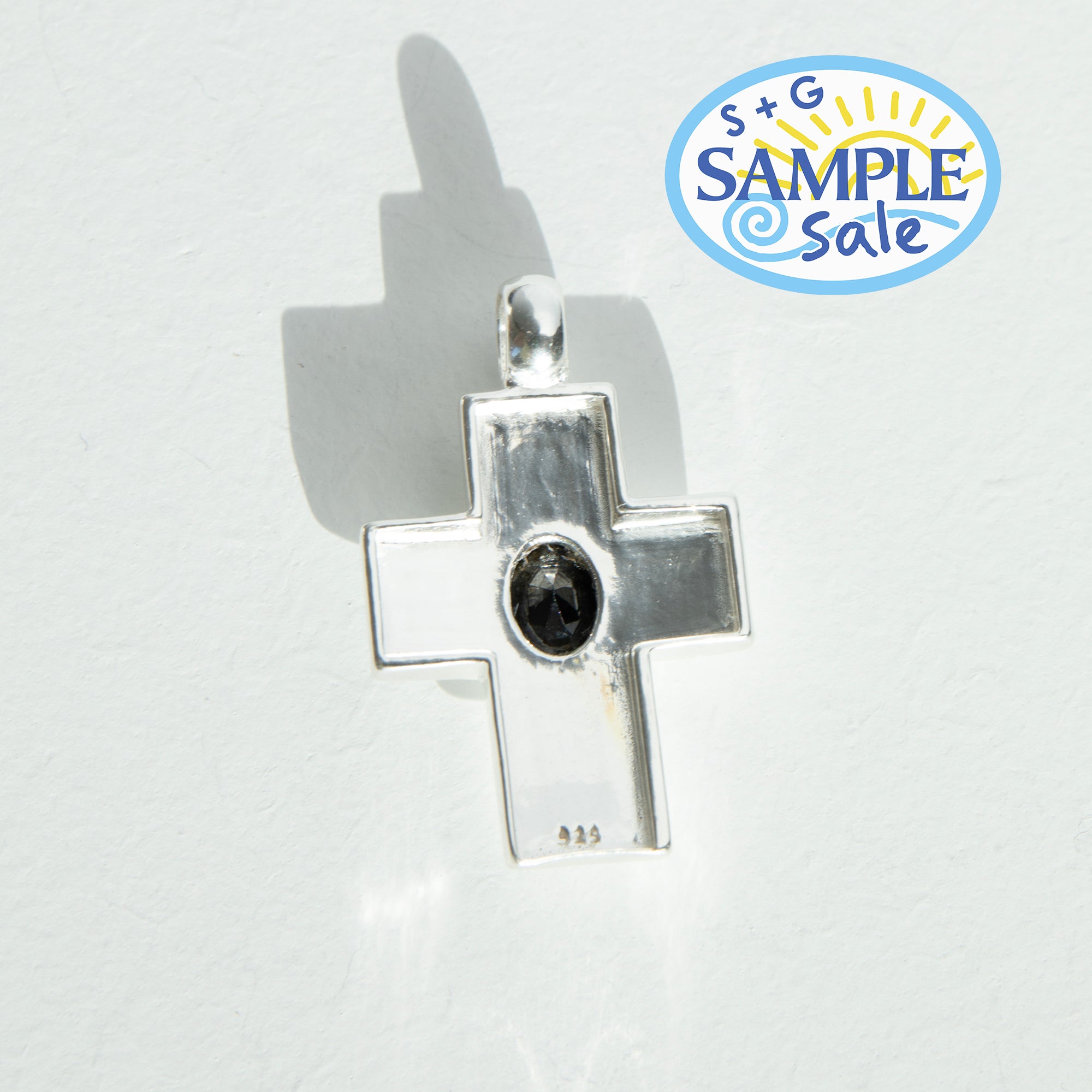 Silver cross pendant with a black gemstone on a white background with 'S+G Sample Sale' logo.