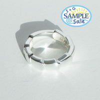Silver ring on a light gray background, featuring S+G Sample Sale logo.