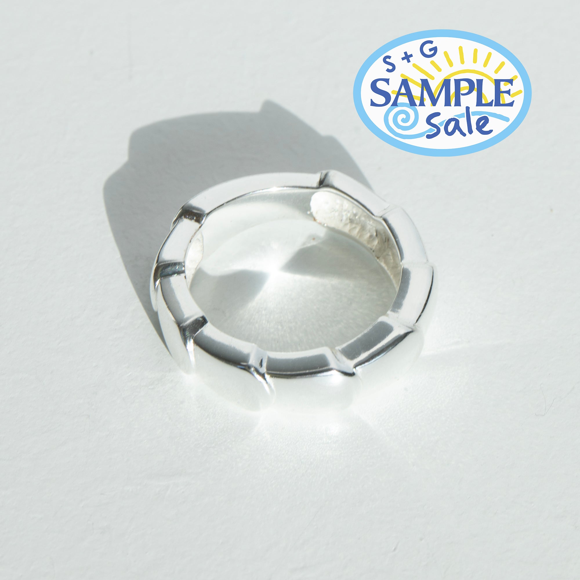 Silver ring on a light gray background with 'S+G Sample Sale' logo.