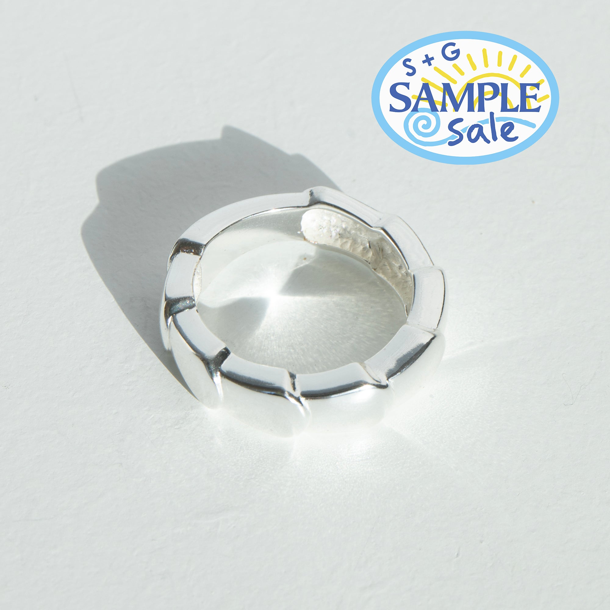 Silver ring on a light gray background with 'S+G Sample Sale' logo.