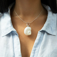 Necklace with a shell pendant worn by a person wearing a light blue shirt - seolgold