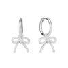 Close-up of an ear wearing a silver bow-shaped earring - seolgold