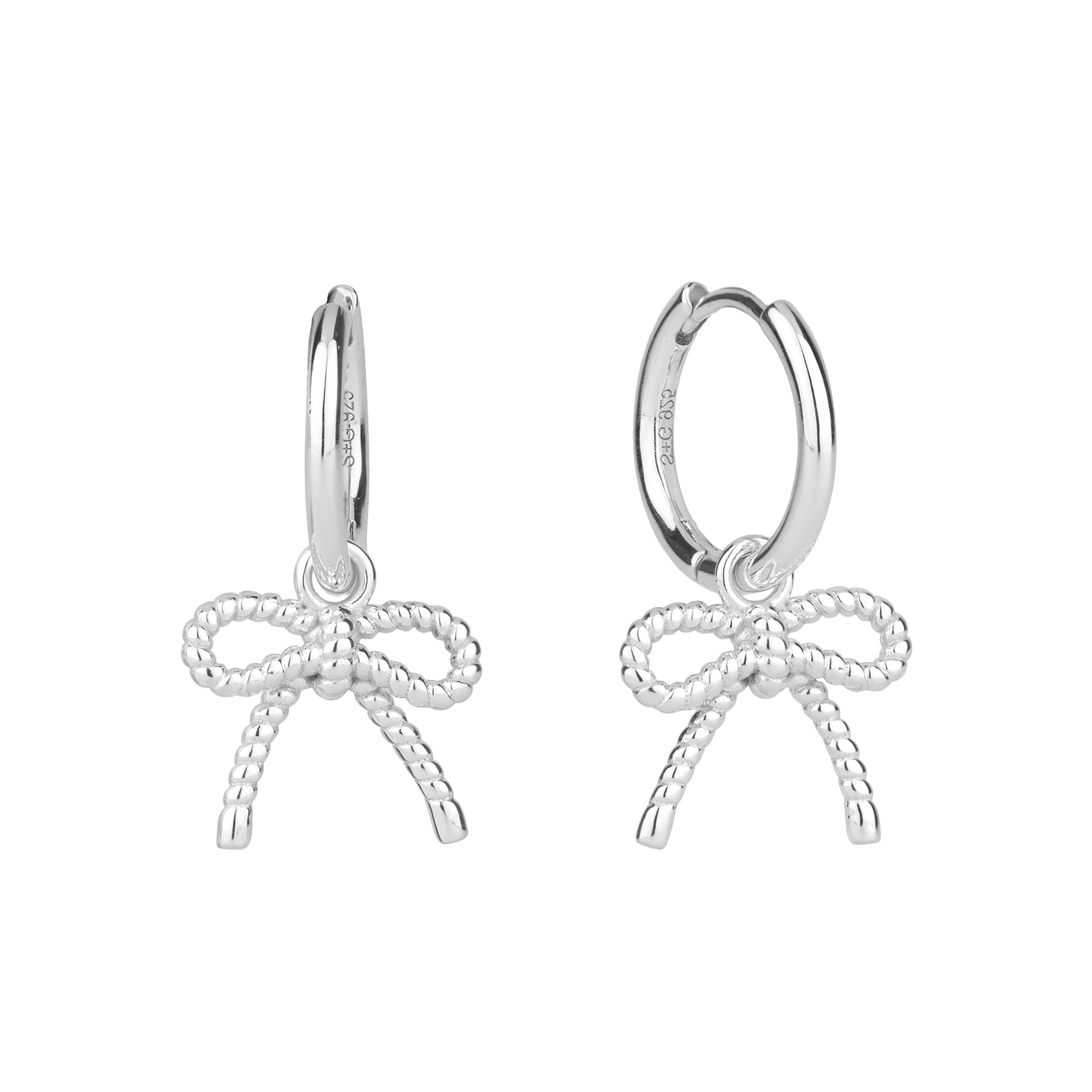 Close-up of an ear wearing a silver bow-shaped earring - seolgold