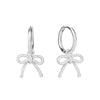 Close-up of an ear wearing a silver bow-shaped earring - seolgold
