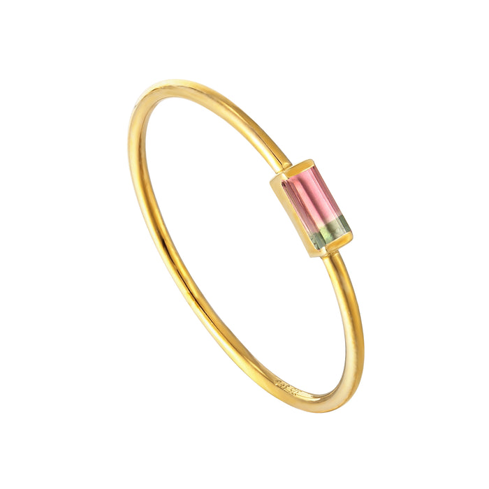 Gold bracelet with a pink and green gemstone on a white background - seolgold