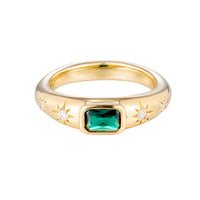 Gold ring with a green gemstone and star designs on a white background - seolgold