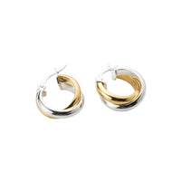 Pair of gold and silver hoop earrings on a white background - seolgold