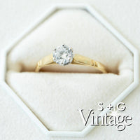 Gold ring with a diamond in a hexagonal box, featuring 'S + G Vintage' branding - seolgold