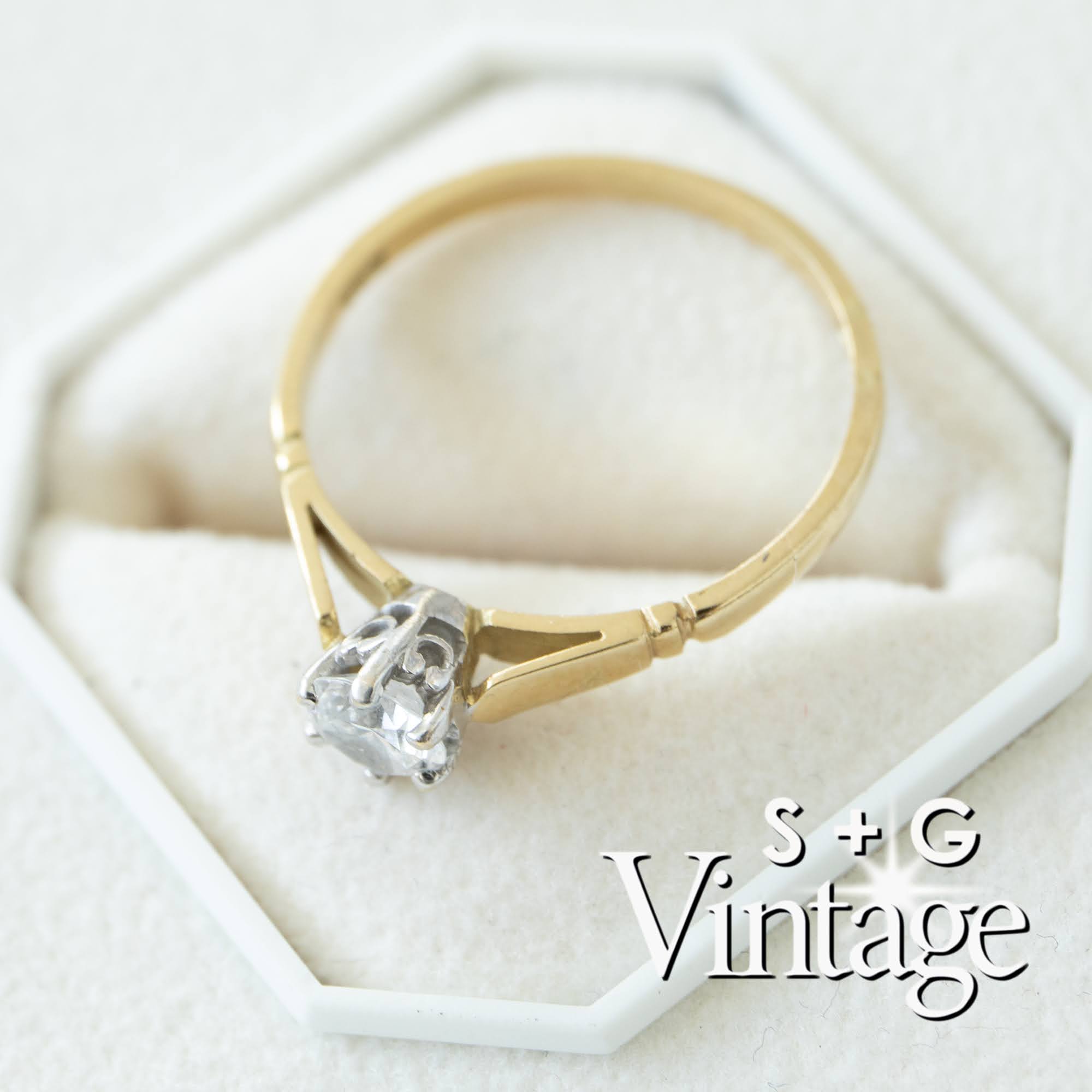 Gold ring with a diamond on a white hexagonal stand, branded 'S + G Vintage' - seolgold