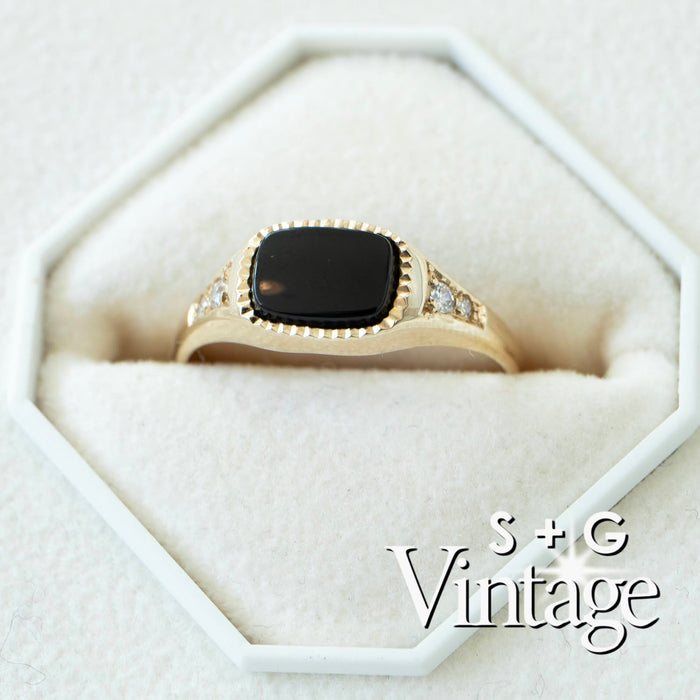 Gold ring with a black stone in a hexagonal white box, featuring 'S + G Vintage' branding - seolgold