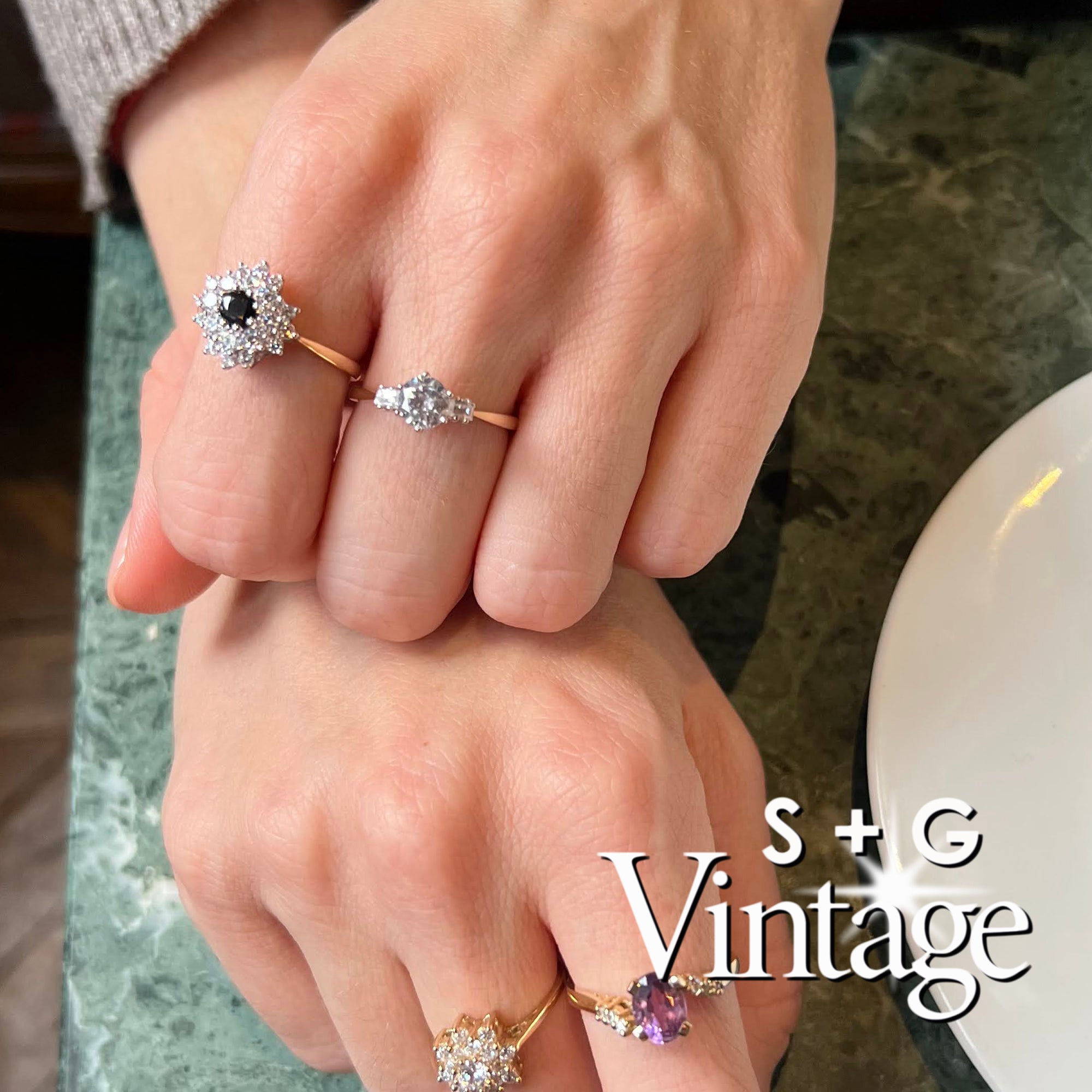 Gold ring with a diamond on a white hexagonal stand, featuring 'S + G Vintage' branding - seolgold