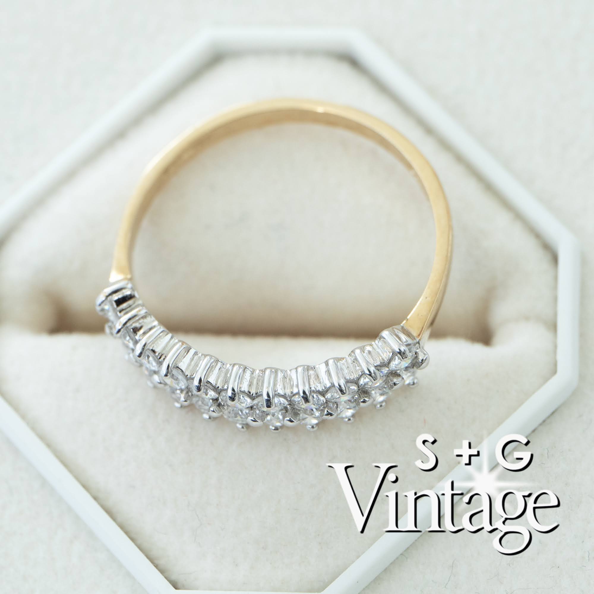 Gold ring with diamond accents on a hexagonal white stand, featuring 'S + G Vintage' branding - seolgold