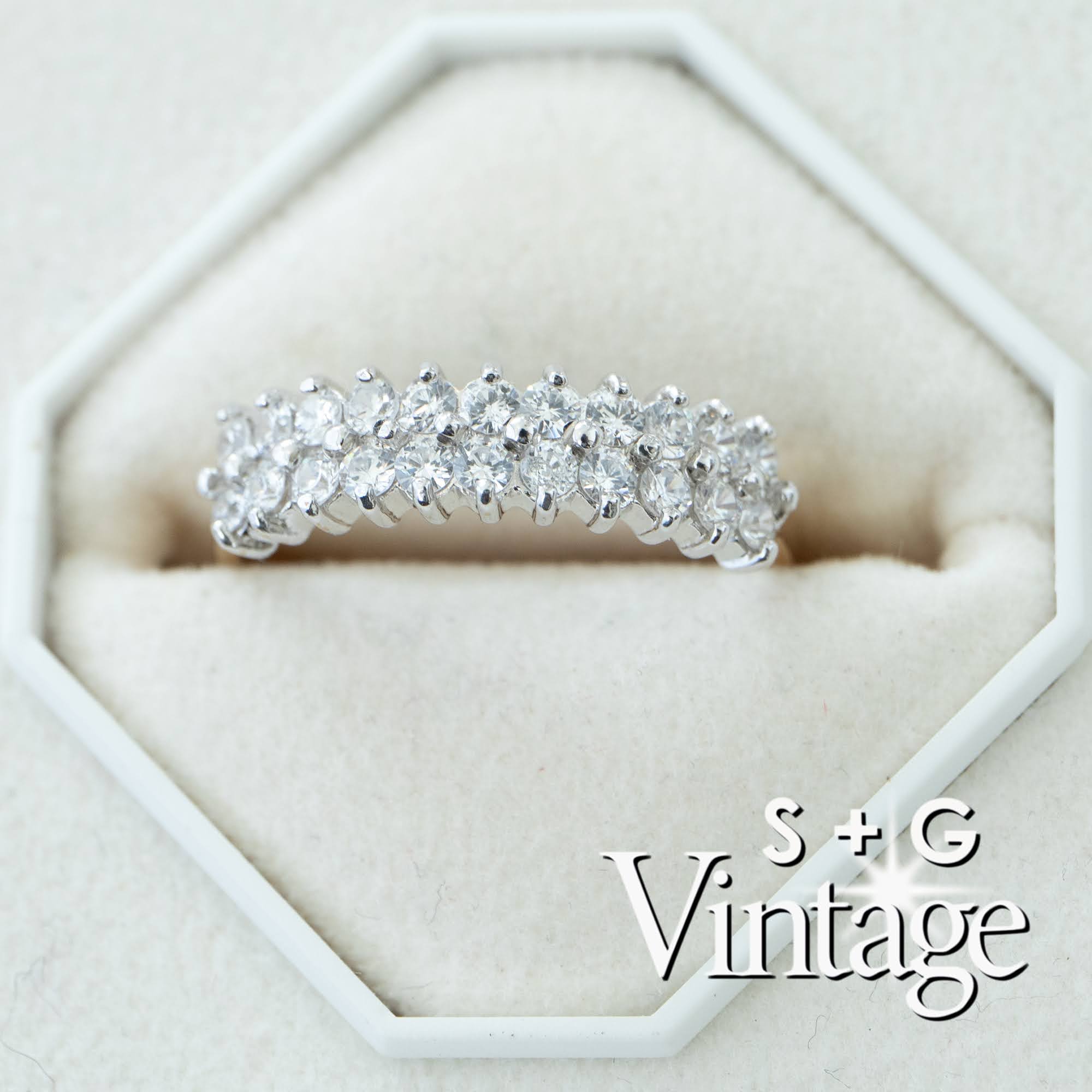 Silver ring with diamonds on a white hexagonal stand, featuring 'S + G Vintage' branding - seolgold