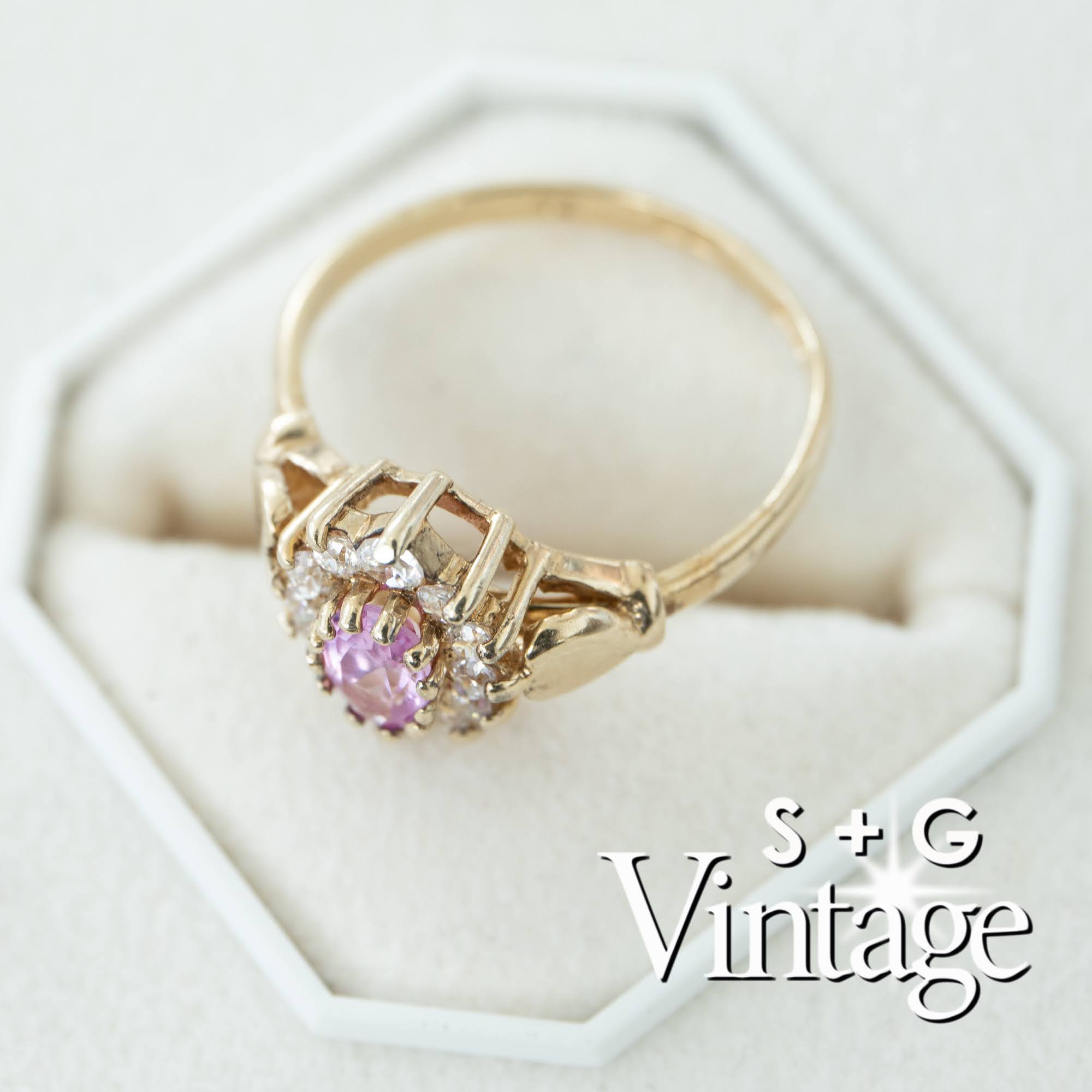Gold ring with a pink gemstone on a white hexagonal stand, branded 'S + G Vintage' - seolgold