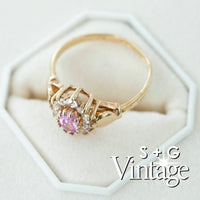 Gold ring with a pink gemstone on a white hexagonal stand, branded 'S + G Vintage' - seolgold