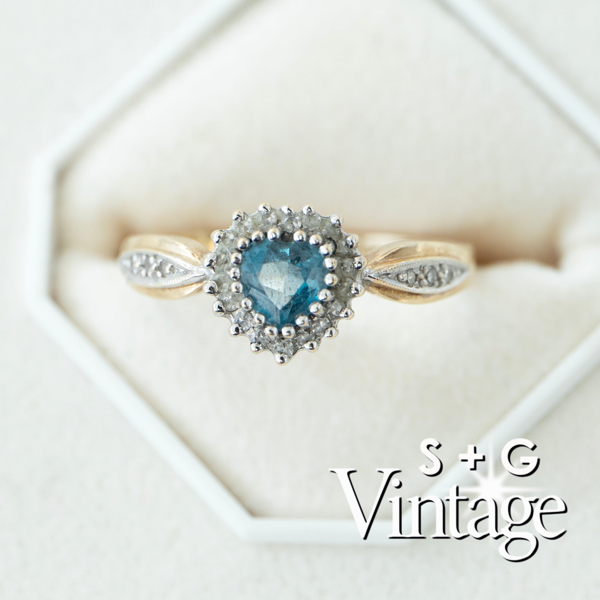 Vintage-style ring with heart-shaped blue gemstone and diamond accents on a white background - seolgold